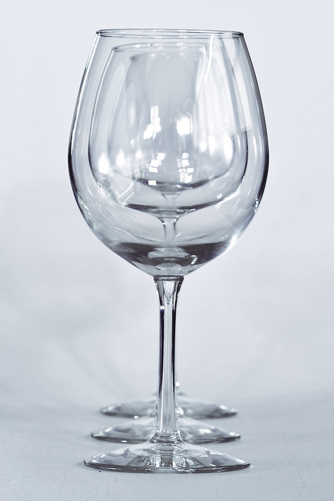 Several wine glasses aligned colinearly with each other and the camera, so that they appear nested within each other